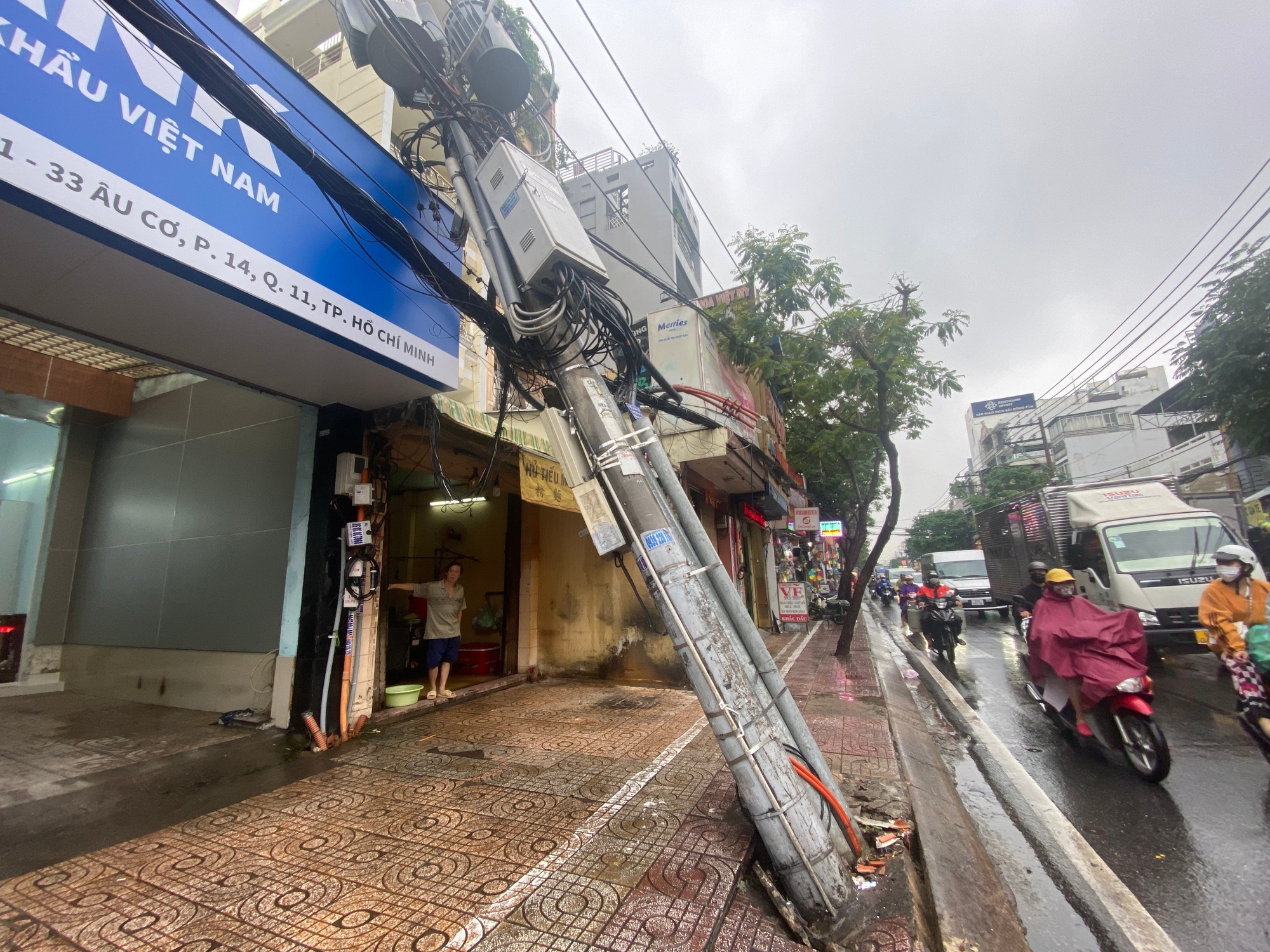 Mưa xối xả cả ngày, trụ điện bật móng đổ vào nhà dân - Ảnh 1.