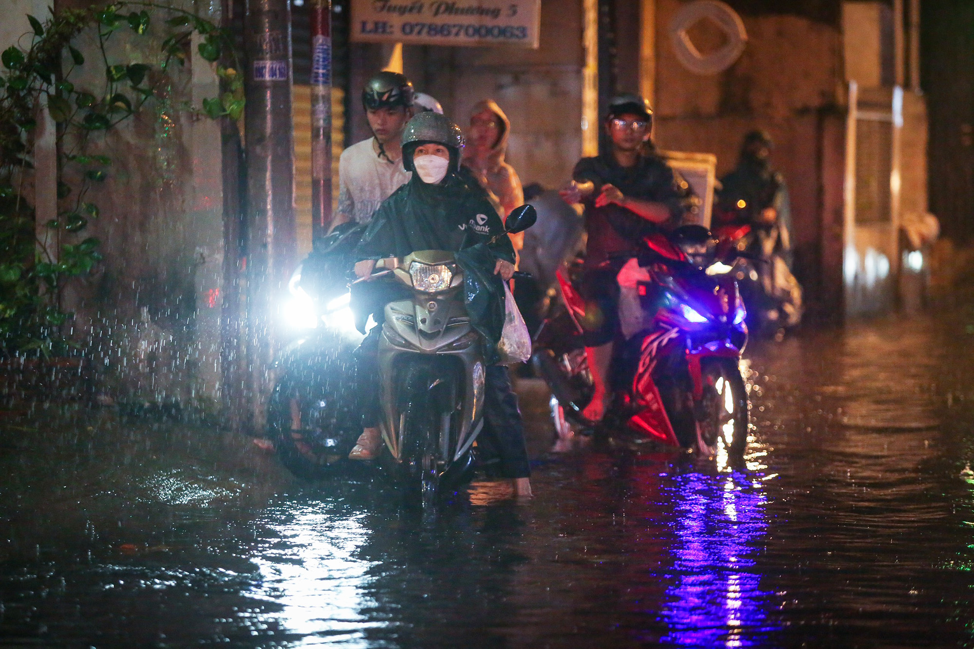 Nhiều tuyến đường tại TP.HCM ngập sâu sau trận mưa,  khiến người dân bì bõm dắt xe giữa dòng nước - Ảnh 5.