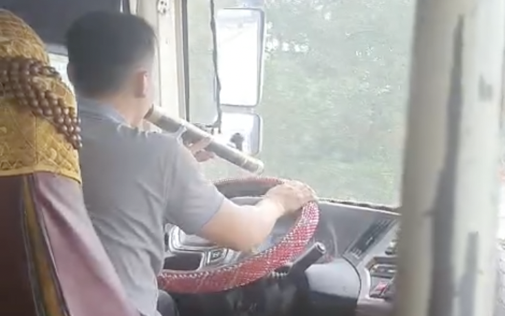 Tài xế xe khách chạy tuyến Hà Nội - Sài Gòn vừa cầm lái vừa rít điếu cày- Ảnh 1.