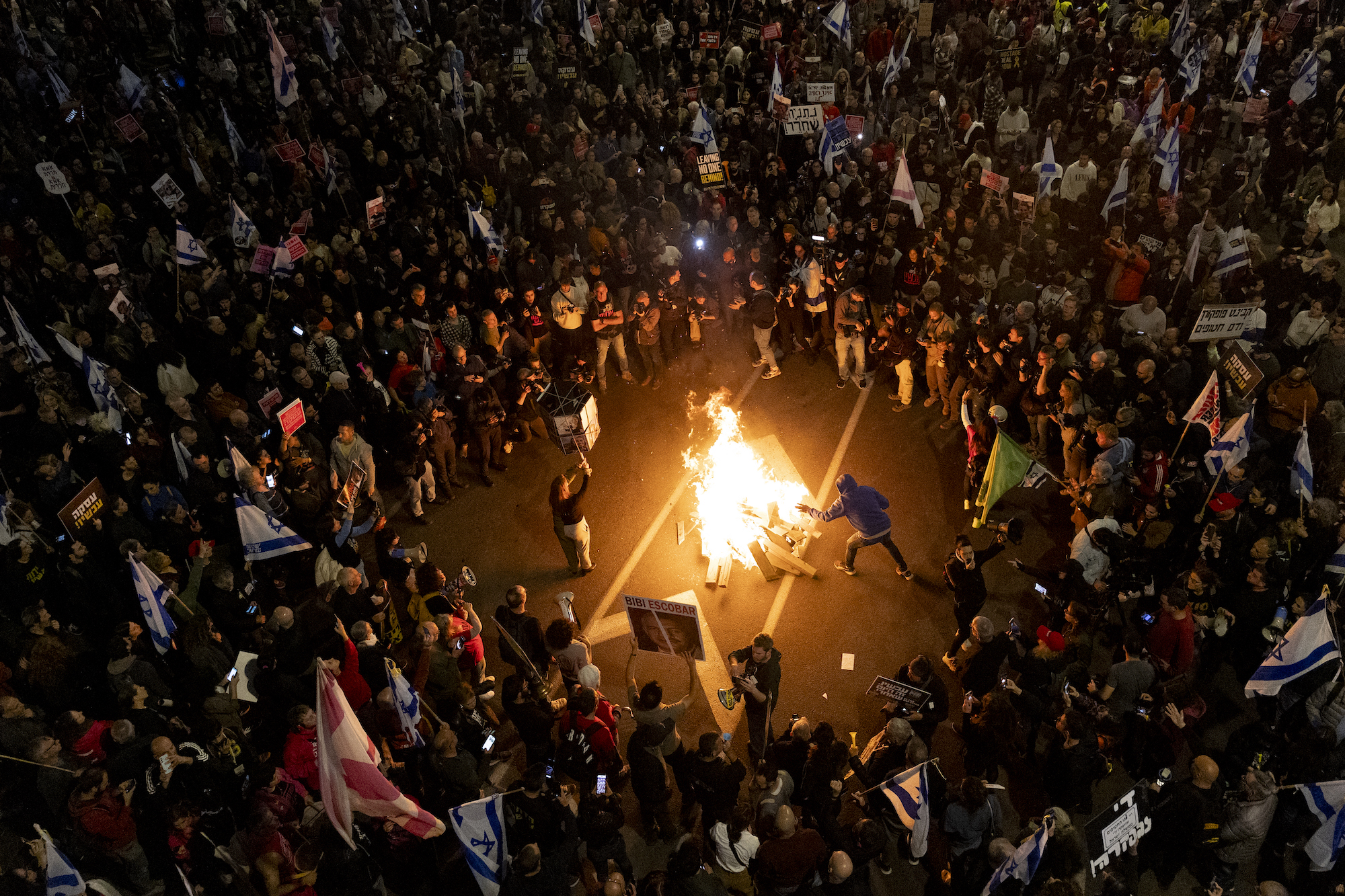 Người biểu tình đốt lửa trên đường phố ở Israel. (Ảnh: CNN)