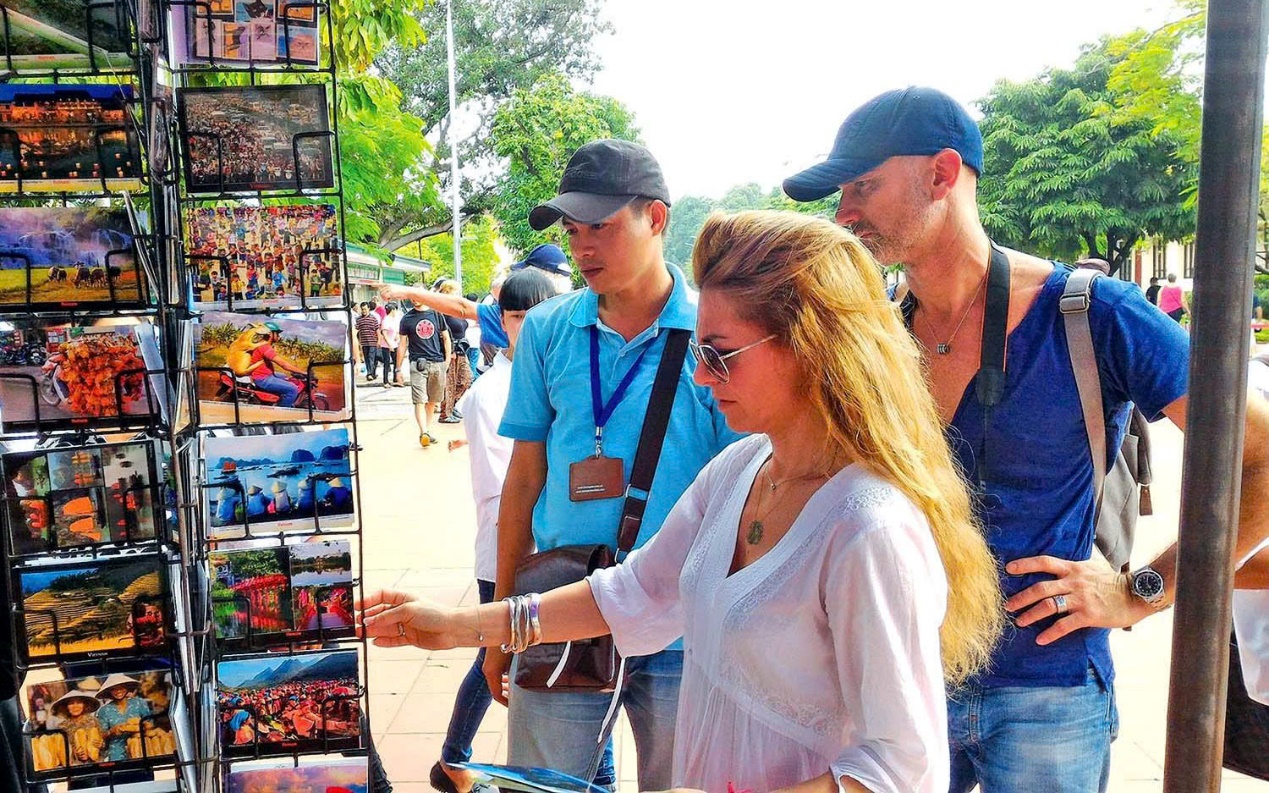 A group of people standing outside looking at a display  Description automatically generated