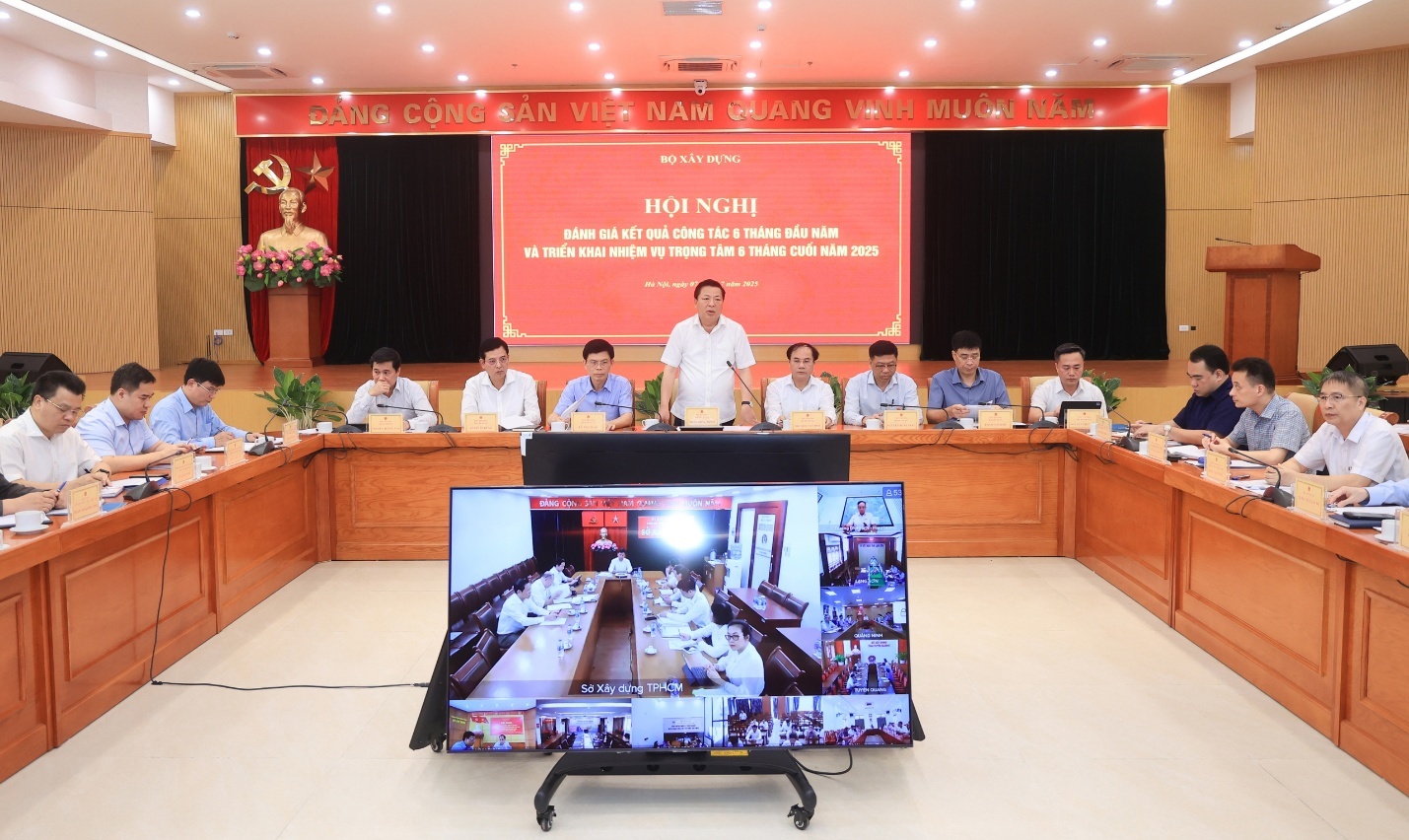 Ministry of Construction completes major workload in first half of 2025, says Minister- Ảnh 2. A group of people sitting in a room AI-generated content may be incorrect.