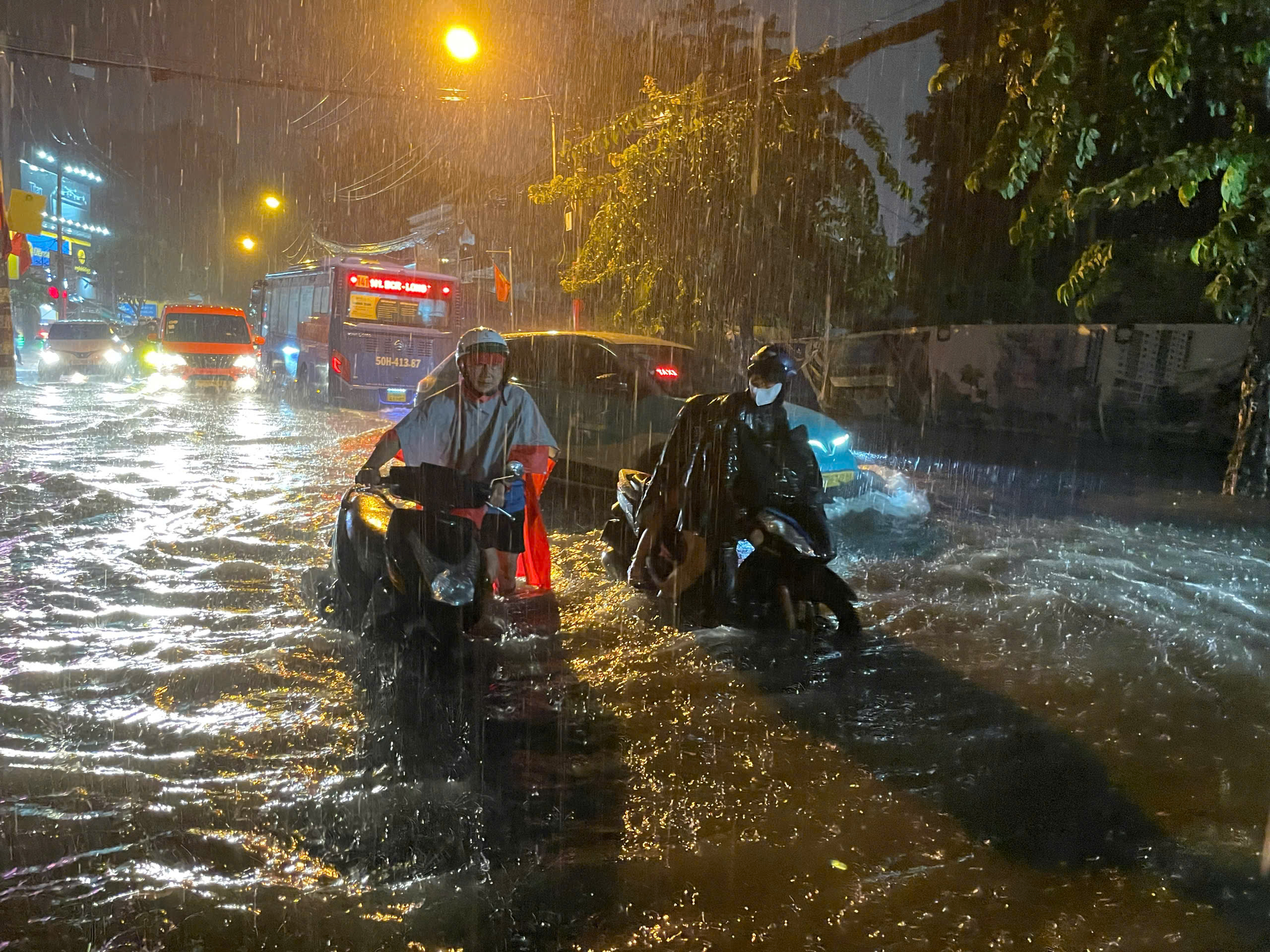 Mưa lớn nhấn chìm nhiều tuyến đường ở TP.HCM, người dân chật vật khi đi lại- Ảnh 7.