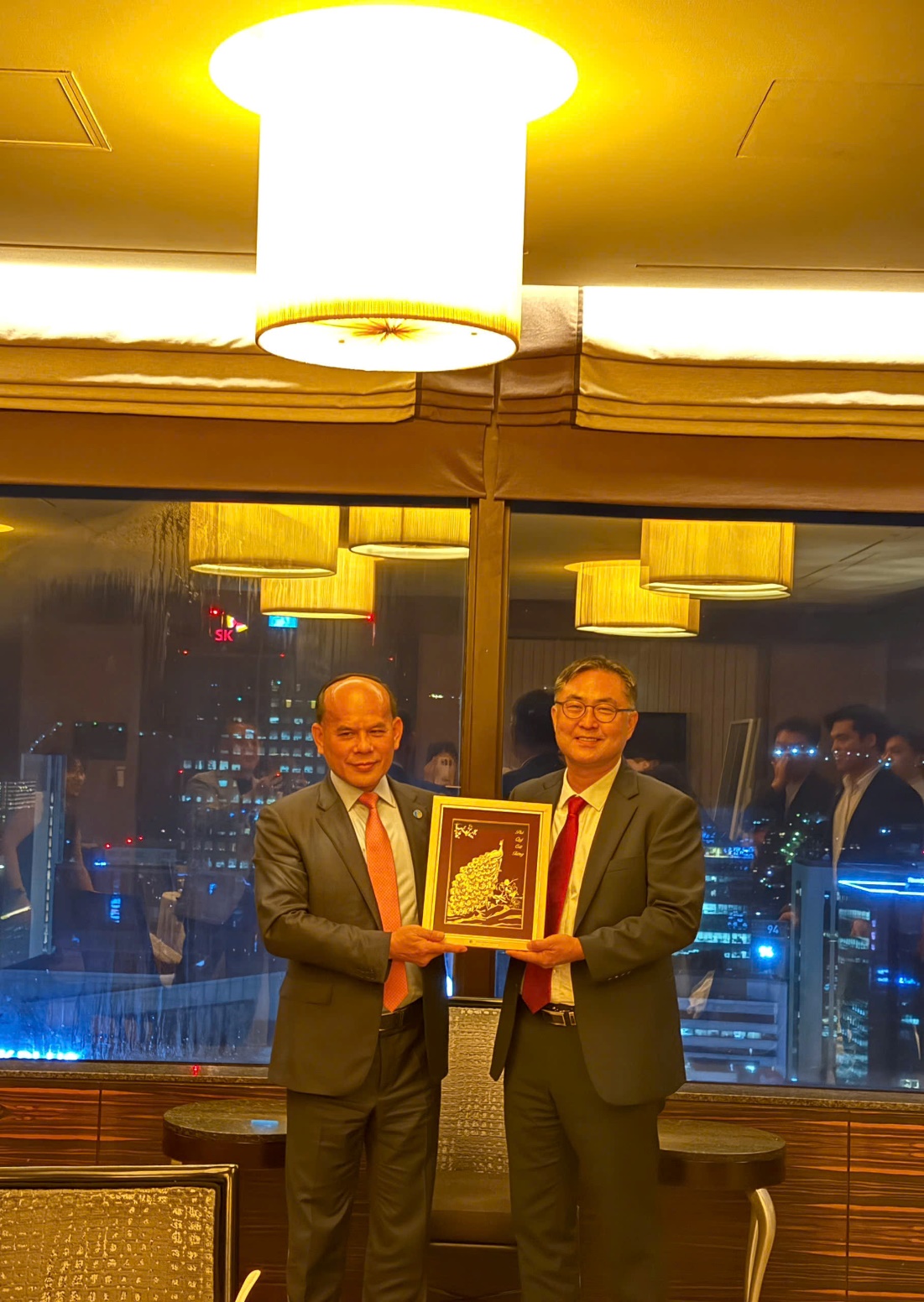 Two men holding a plaque  AI-generated content may be incorrect.