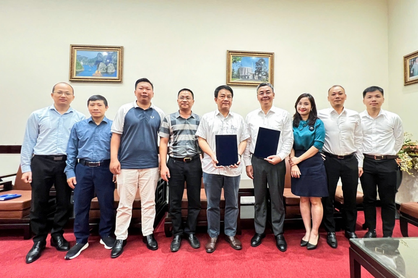 A group of people standing together holding tablet  AI-generated content may be incorrect.