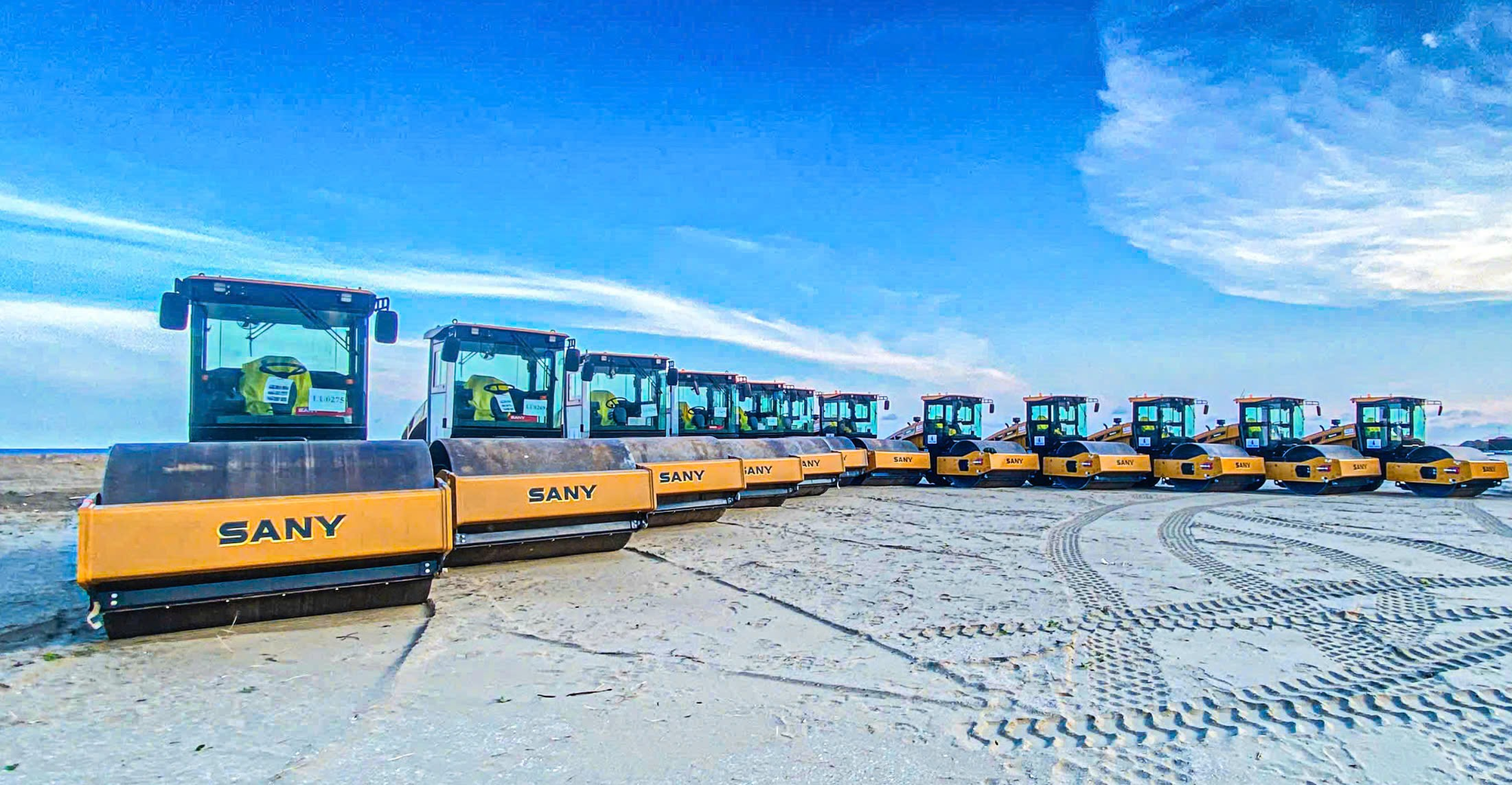 A group of construction vehicles in a line  AI-generated content may be incorrect.
