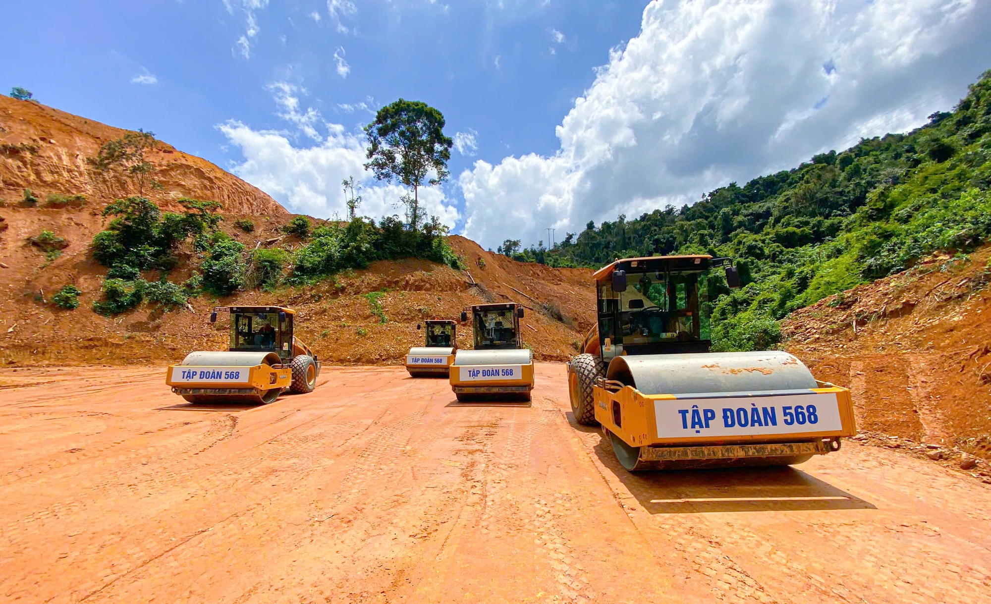 Several construction vehicles on a dirt road  AI-generated content may be incorrect.