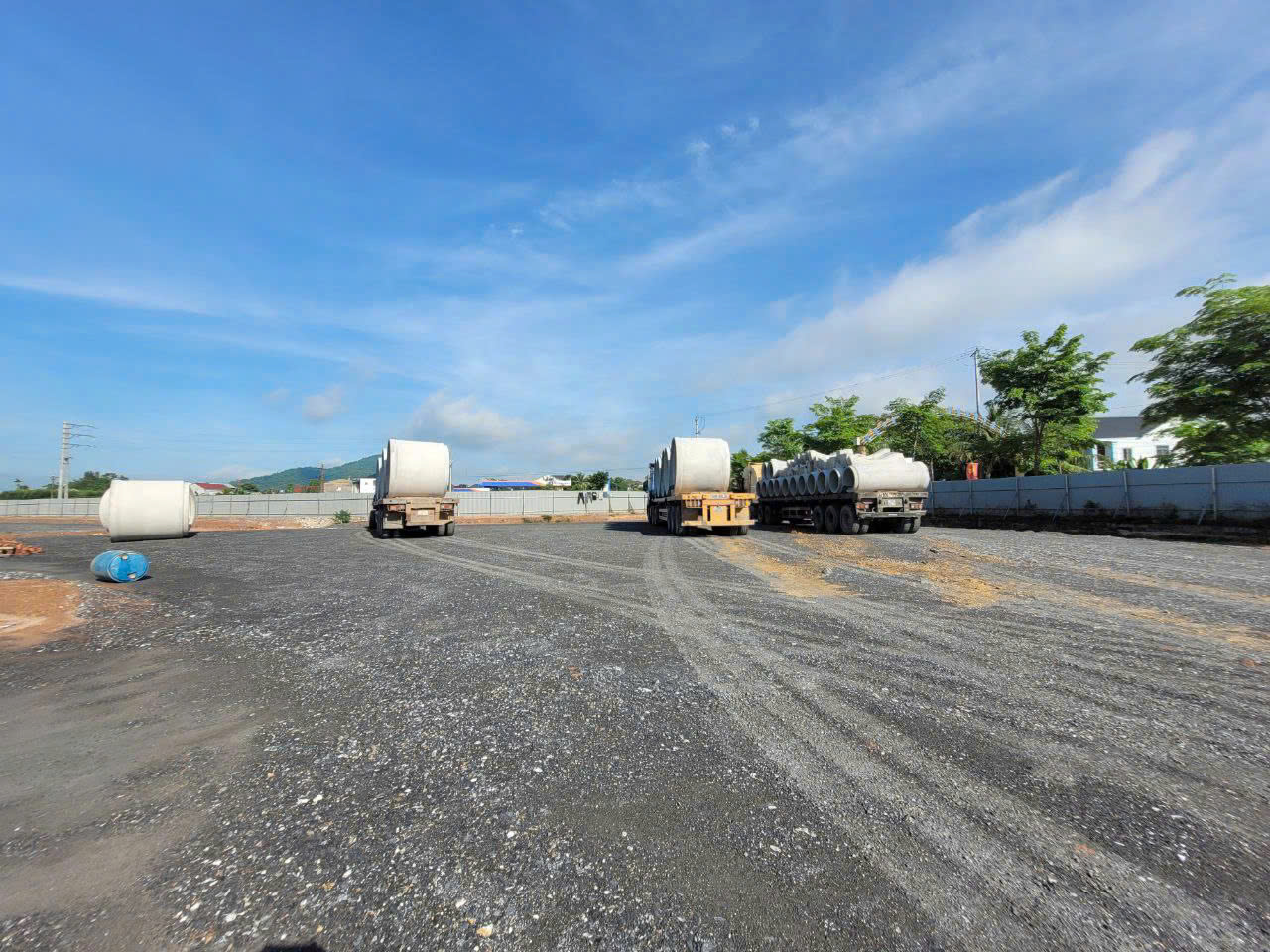 A group of trucks parked on a gravel lot  AI-generated content may be incorrect.