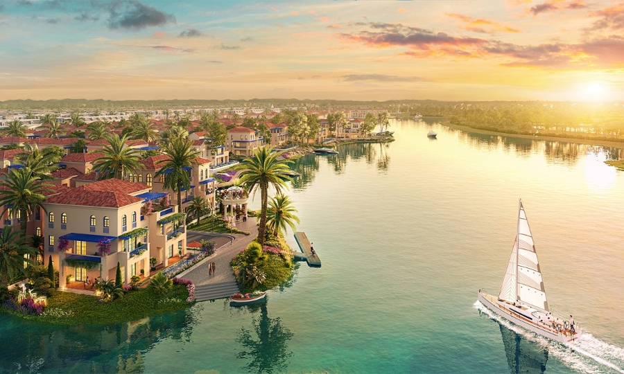 Mở cửa ngôi nhà Gold Coast Vũng Tàu: Khám phá tuyệt tác kiến trúc bên vịnh- Ảnh 4. A body of water with buildings and a boat AI-generated content may be incorrect.