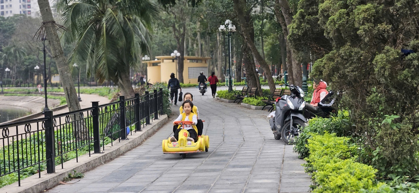 A child riding a toy car on a sidewalk  AI-generated content may be incorrect.