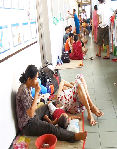 Phụ huynh và trẻ mắc bệnh tay chân miệng nằm ngoài hành lang Bệnh viện Nhi Đồng 1