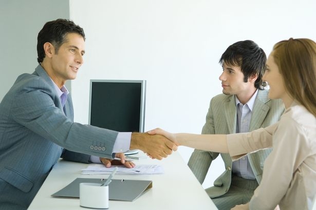 PROD-Young-couple-sitting-across-desk-from-busines