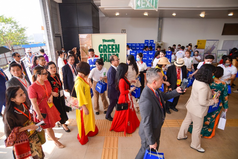 A group of people walking in a room  Description automatically generated