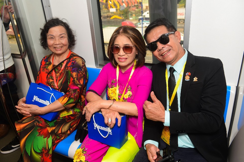 A group of people sitting on a bus  Description automatically generated