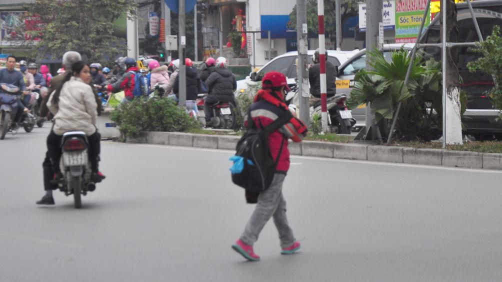 Có cầu vượt nhưng cháu học sinh này bắt chước người lớn tự sang đường, độ nguy hiểm cao.