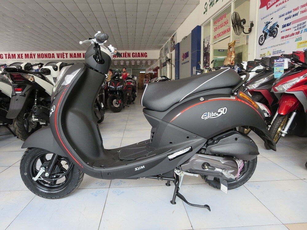 SYM Elite 50 là dòng xe nhắm tới đối tượng tuổi teen thích dáng xe nhỏ nhắn, cổ điển. Đặc biệt, với những đường cong mềm mại, chiếc xe như được thiết kế dành riêng cho các bạn nữ. Hệ thống đèn của xe nổi bật với thiết kế khối tròn có sự kết hợp giữa hiện đại và cổ đại. SYM đã trang bị cho mẫu xe này hệ thống phanh trống cho cả bánh trước và bánh sau. Phuộc trước là phuộc ống lồng, phuộc sau là loại lò xo trụ.
Xe sử dụng động cơ 4 thì, 49.5cc SYM Elite cho công suất tối đa là 3.6 mã lực/8.000 vòng/phút. Mô-men xoắn cực đại là 3.4 Nm/ 7.000 vòng/ phút.
Giá xe: Từ 21.890.000 - 22.390.000 đồng