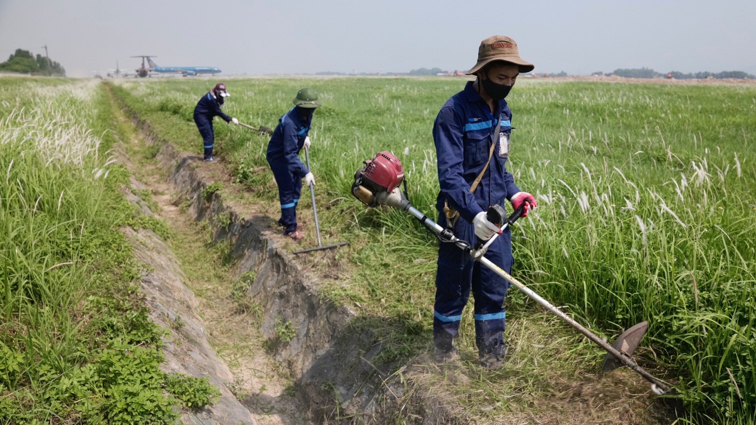Đội bảo trì sân đường - Trung tâm Khai thác khu bay Nội Bài - thực hiện nạo vét mương