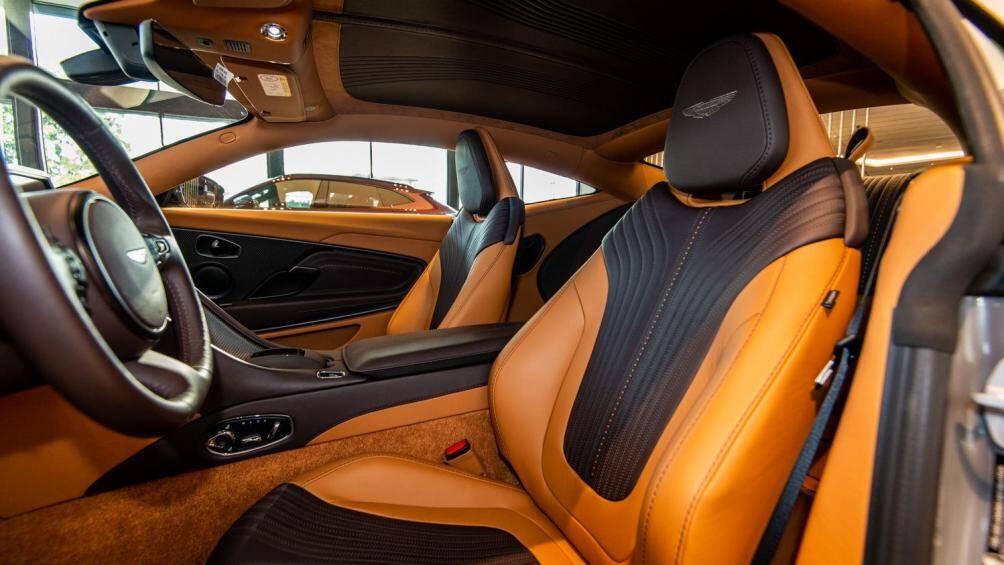 Ghế ngồi trên DB11 mang thiết kế thể thao, tựa đầu ghế thêu logo Aston Martin