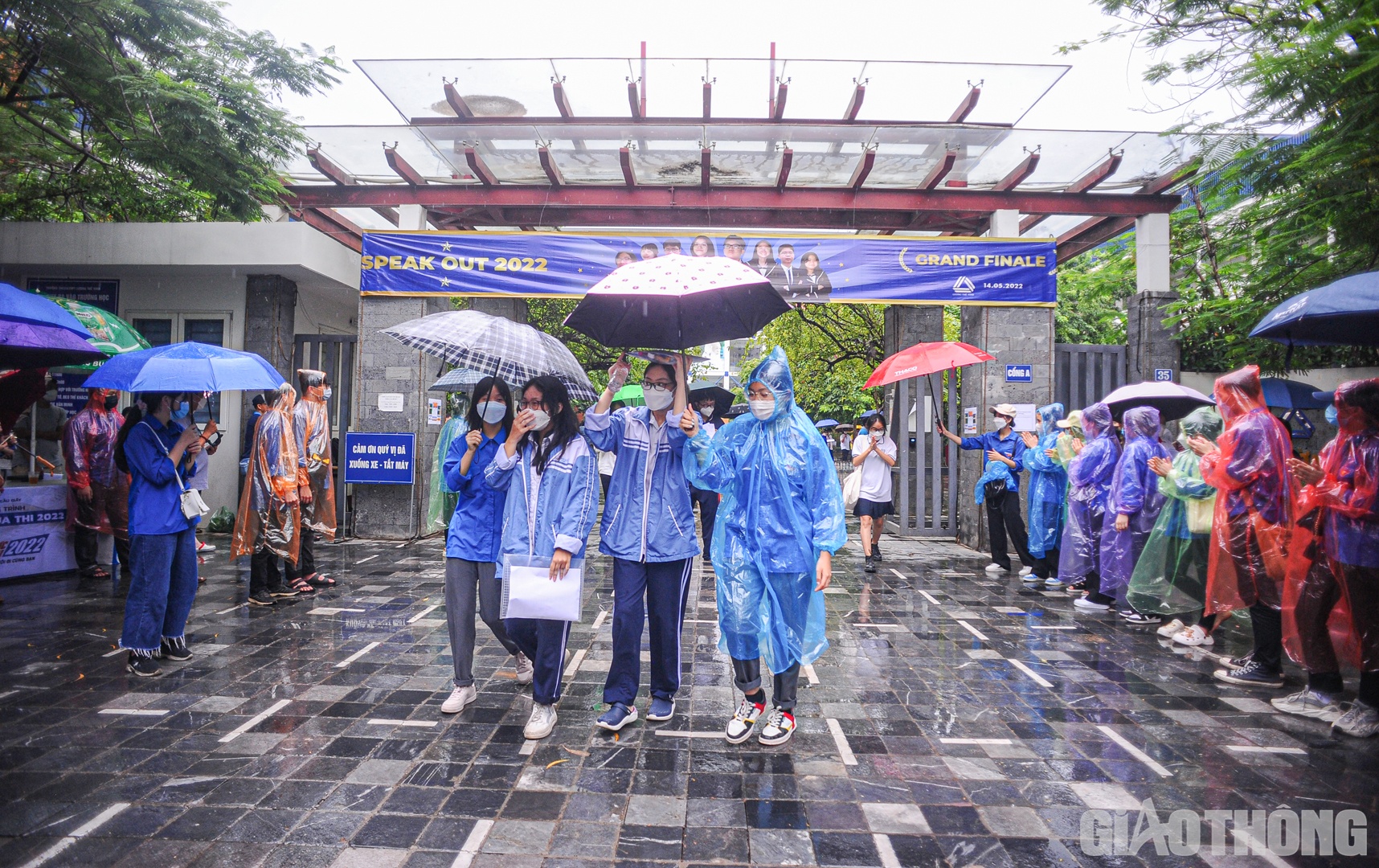 Đúng 16h, các thí sinh đã hoàn thành bài thi Toán với hình thức thi trắc nghiệm khách quan. Để tránh cho các sĩ tử bị ướt, các tình nguyện viên đã dùng ô để hỗ trợ thí sinh đi ra bên ngoài.