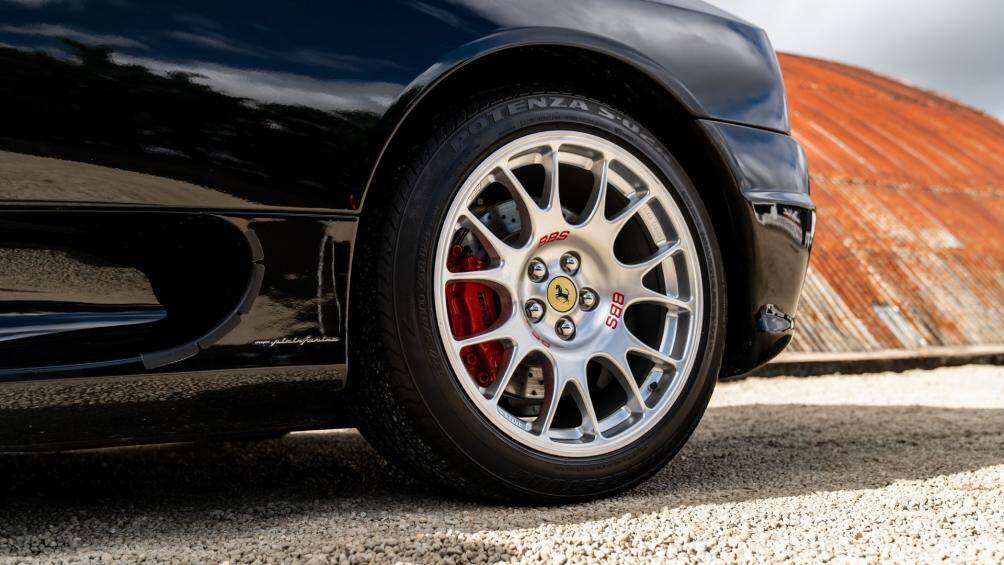 Ngoại thất Ferrari 360 Spider mang màu sơn đen Nero truyền thống, đi cùng bộ mâm BBS đúc đa chấu màu bạc