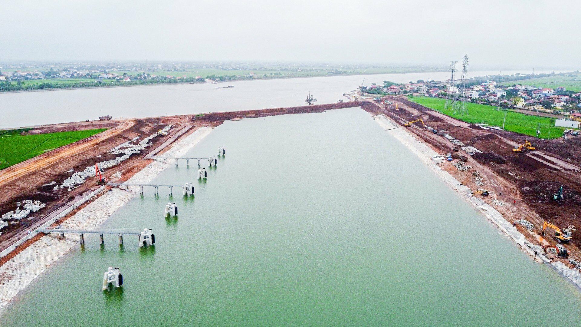Cụm công trình kênh nối Đáy - Ninh Cơ chia làm 4 gói thầu xây lắp chính gồm: Gói thầu CV-A2.9-NDTDP: Cầu qua kênh nối Đáy - Ninh Cơ; 3 gói thầu CV-A2.6-NDTDP, CV-A2.7-NDTDP và CV-A2.8-NDTDP xây dựng âu và kênh dẫn, được khởi công tháng 3/2021. Theo đó, xây dựng kênh nối giữa sông Đáy và sông Ninh Cơ với chiều dài khoảng 1km; chiều rộng đáy kênh từ 90m - 100m (Ảnh: Kênh đào)