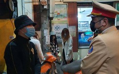 Loạt tài xế xe máy chở 3-4 người xếp hàng ký phạt trong đêm ở Hà Nội