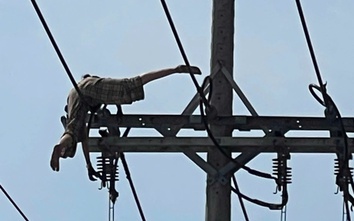 Người phụ nữ nằm vắt vẻo trên dây điện cao thế rồi rơi xuống đất
