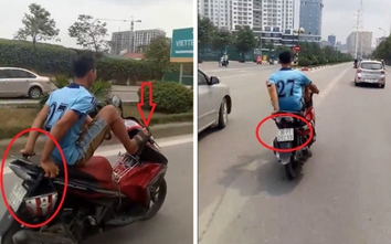 Nam thanh niên đầu trần lái xe máy bằng chân đi vào làn BRT